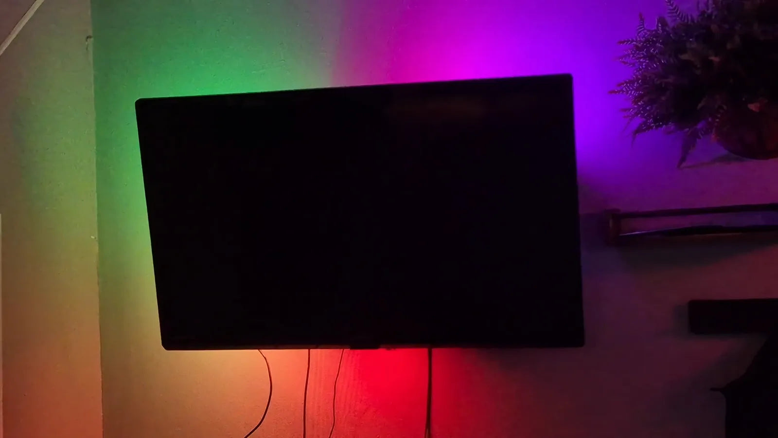 TV off with a gradient of light on the wall behind it